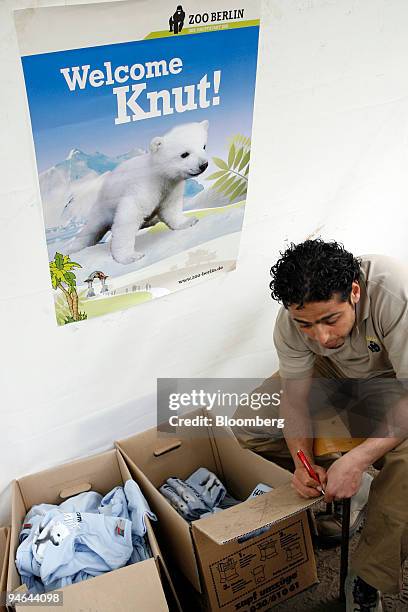 Zoo employee Khaled El-Haj-Moussa checks inventory on Knut the baby polar bear t-shirts for sale at the Berlin Zoo in Berlin, Germany, Tuesday, April...