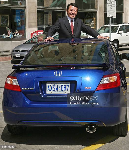 Hiroshi Kobayashi, president and CEO of Honda Canada Inc., poses in a Hond Civic following at a news conference in Toronto, Ontario, Canada...