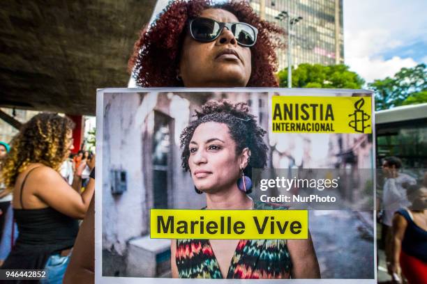 People gather in Paulista Avenue, Sao Paulo, Brazil on April 14, 2018 during a demonstration marking one month of activist Marielle Franco's murder....