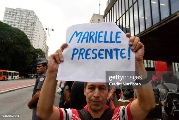 People gather in Paulista Avenue, Sao Paulo, Brazil on April 14, 2018 during a demonstration marking one month of activist Marielle Franco's murder....