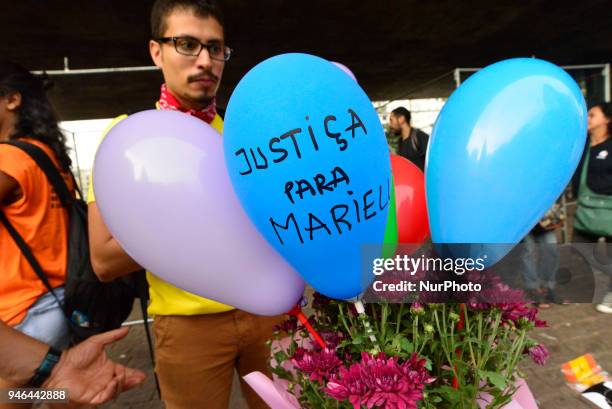 People gather in Paulista Avenue, Sao Paulo, Brazil on April 14, 2018 during a demonstration marking one month of activist Marielle Franco's murder....