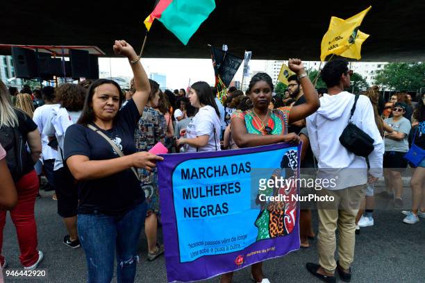 People gather in Paulista Avenue, Sao Paulo, Brazil on April 14, 2018 during a demonstration marking one month of activist Marielle Franco's murder....