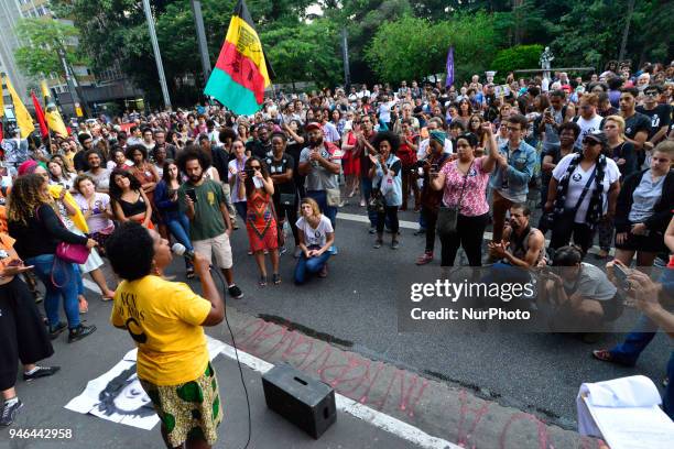 People gather in Paulista Avenue, Sao Paulo, Brazil on April 14, 2018 during a demonstration marking one month of activist Marielle Franco's murder....