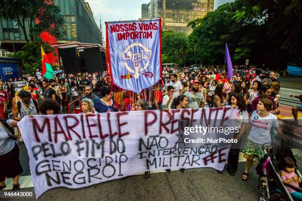 People gather in Paulista Avenue, Sao Paulo, Brazil on April 14, 2018 during a demonstration marking one month of activist Marielle Franco's murder....