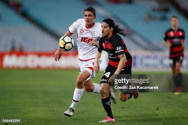 Raul Llorente of the Wanderers and George Blackwood of Adelaide chase down the ball during the round 27 A-League match between the Western Sydney...