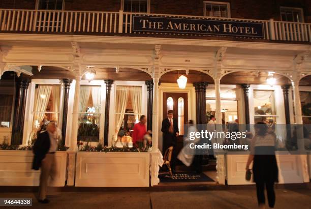 Pedestrians pass by the American Hotel in Sag Harbor, New York, on Aug. 18, 2007. As the Dow Jones Industrial Average dropped as much as 12 percent...