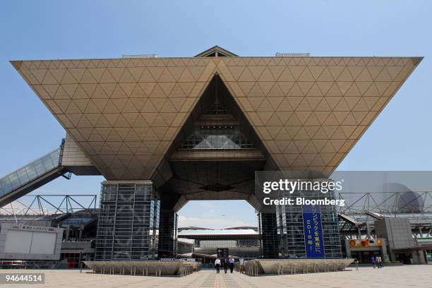 Businessmen walk outside the Tokyo International Exhibition Center, also known as Tokyo Big Site, in Tokyo, Japan, on Sunday, June 3, 2007. The...
