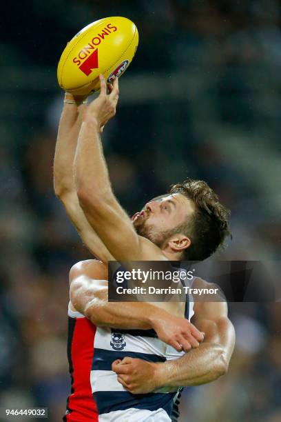 Jordan Murdoch of the Cats marks the ball in front of Sebastian Ross of the Saints during the round four AFL match between the Geelong Cats and the...