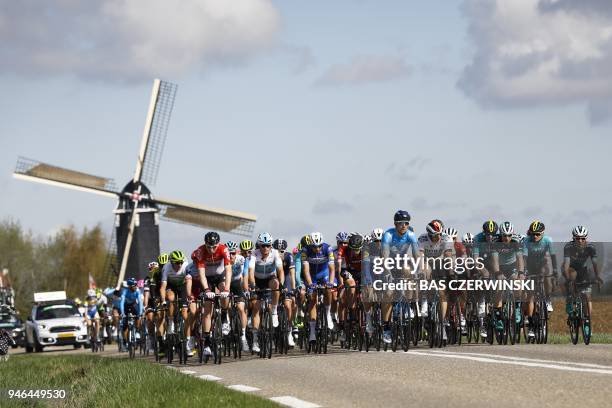 The pack rides past the Hubertus mill during the Amstel Gold Race in Beek on April 15, 2018. / AFP PHOTO / ANP / Bas Czerwinski / Netherlands OUT