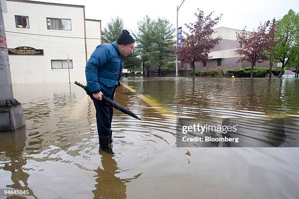 Bob Kiley, a 70-year resident of Peabody, Massachusetts, stands amongst flood waters in Peabody, Tuesday, May 16, 2006.