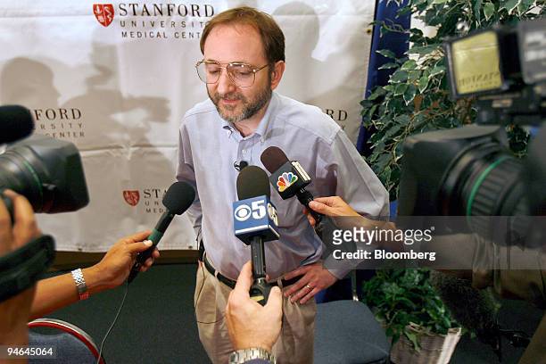 Andrew Fire of the Stanford University School of Medicine talks to member of the media during a news conference at the school in Palo Alto,...