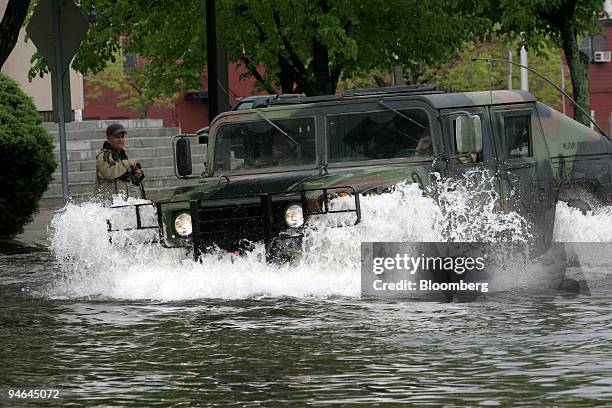 National Guard Humvee drives through flood waters in Peabody Square in Peabody, Massachusetts, Tuesday, May 16, 2006.