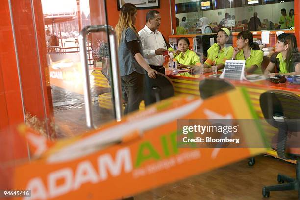 People buy tickets in Adam Air's ticketing office at Soekarno-Hatta International Airport, in Cengkareng, near Jakarta, Indonesia, on Monday, April...