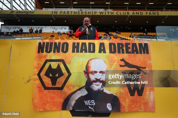 Wolverhamton Wanderers fan looks at his phone inside the stadium prior to the Sky Bet Championship match between Wolverhampton Wanderers and...