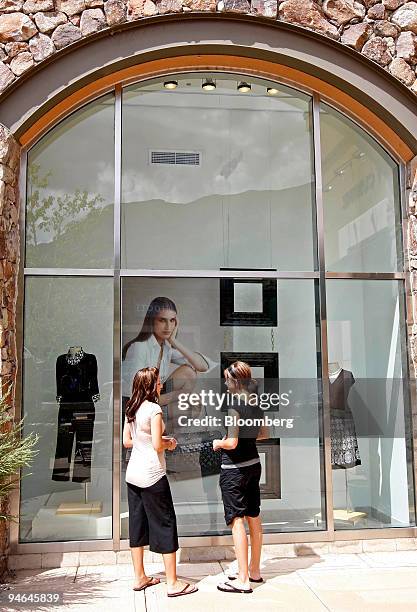 Jessica Holbrook, left, and Trisha Barton look at a window display outside the Ann Taylor store at the Riverwoods Shopping Center in Provo, Utah,...