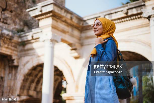 young muslim woman traveller in kaleici (old town of antalya) - west asia stock pictures, royalty-free photos & images