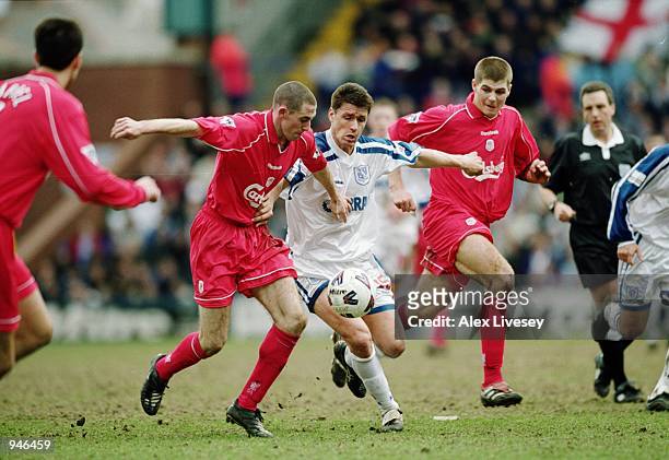 Paul Rideout of Tranmere Rovers runs through the middle of Stephen Wright and Steven Gerrard both of Liverpool during the AXA Sponsored FA Cup...