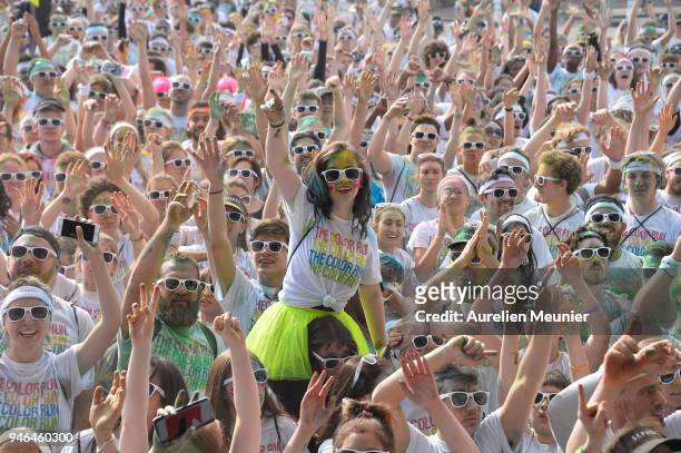 People take part in the fifth edition of The Colour Run starting at Hotel de Ville and finishing at the Eiffel Tower on April 15, 2018 in Paris,...