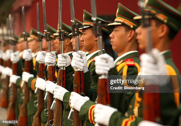 Chinese People's Liberation Army soldiers drill with their bayonettes during training at their barracks near Tiananmen Square in Beijing, China,...