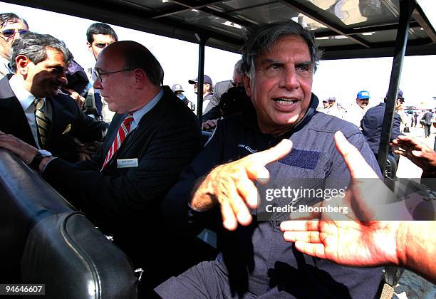 Ratan Tata, right, chairman of Tata Group shakes hands after a ride in an N-16 fighter jet during the Aero India 2007 air show in Bangalore, India,...