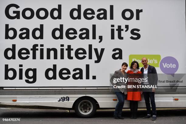British politicians, Labour Party MP Chuka Umunna , Liberal Democrat MP Layla Moran and Green MP Caroline Lucas pose in front of an advertising board...