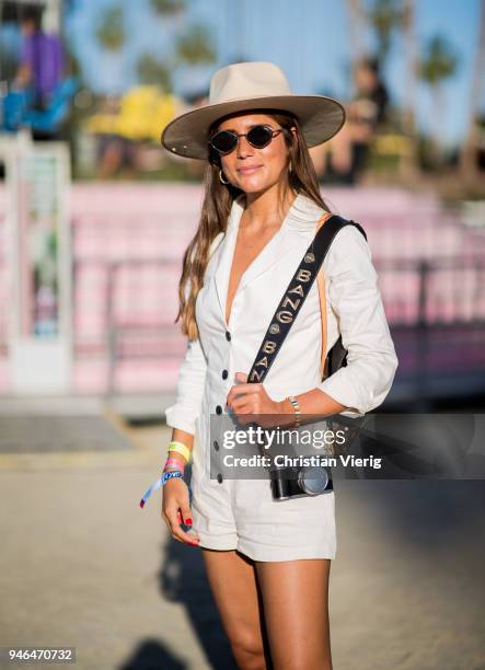 Belen Hostalet wearing hat, jumpsuit, boots is seen at Revolve Festival on April 14, 2018 in Indio, California.