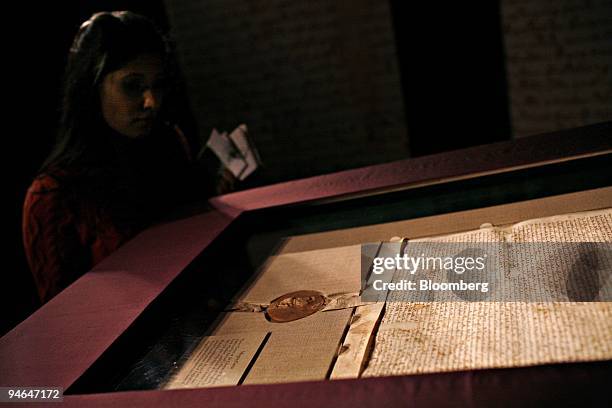 Visitor to Sotheby's New York looks at a 1297 copy of the Magna Carta on display at the auction house in New York, U.S., on Friday, Dec. 7, 2007. The...