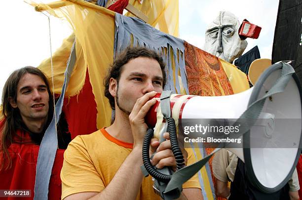Alexis Passadakis, campaigner for Gerechtigkeit-Jetzt, or Justice Now, speaks into a megaphone at a protest against theGroup of Eight Summit to take...