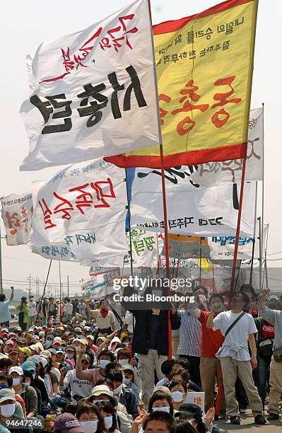 Social activists and students sho0ut slogans and hold banners during a rally to protest against the relocation of the U.S. Army base in Pyeongtaek,...