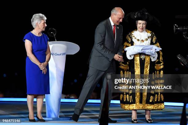 The President of the Commonwealth Games Federation, Louise Martin, looks on as Chairman of Commonwealth Games England Ian Metcalfe presents the...