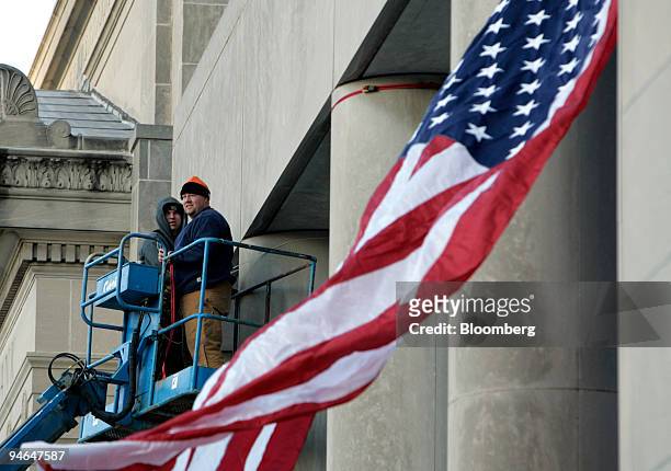 Workers tie down a giant American flag outside of the Old Illinois State Capitol, on Friday, February 9 the day before Illinois senator Barack Obama...