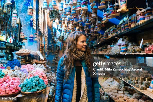 woman walks through local small shop - turismo esperienziale foto e immagini stock