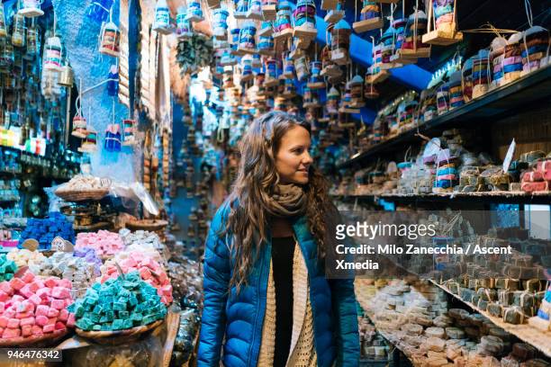 woman walks through local small shop - morocco tourist stock pictures, royalty-free photos & images