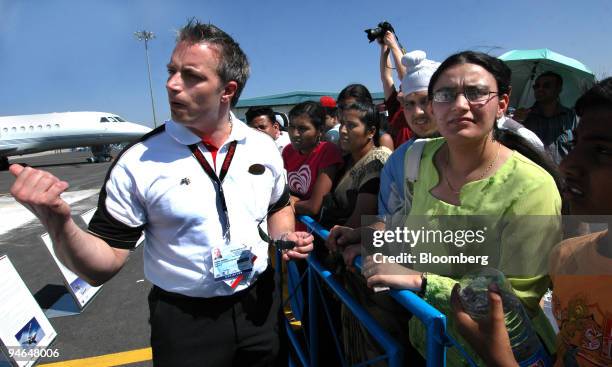 Jonas Harma, a representative of Gripen International of Sweden, shares a word with the visitors during the Aero India 2007 air show in Bangalore,...