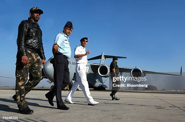 Indian Defense officials walk past a Globemaster III U.S. Air Force cargo plane during Aero India 2007 in Bangalore, India, on Friday, Feb. 9, 2007.