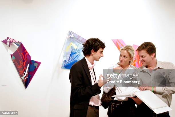 Abraham Orden, left, exhibitor of Ration 3 located in San Francisco discusses pieces of the gallery to Alexa Wesner and Brent Hasty during the...