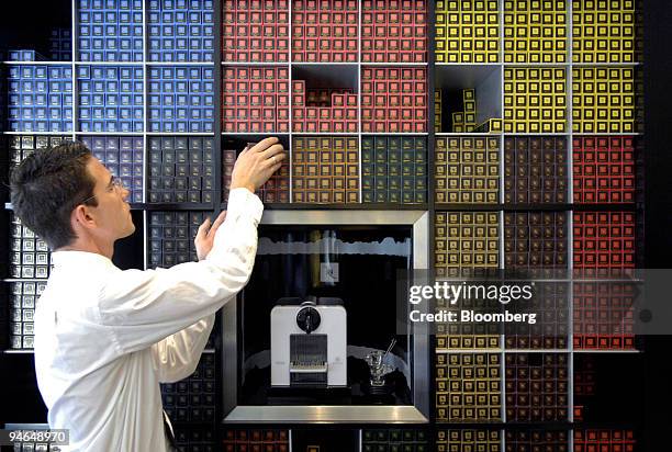 An employee arranges Nespresso coffee at a Nestle Nespresso Shop in Bern, Switzerland, Wednesday, Aug. 15, 2007. The world's largest coffee maker is...