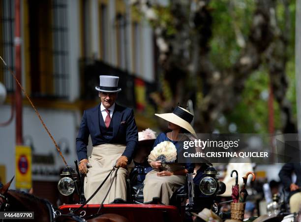 Participants wearing period dresses wait for parading in the XXXIII "Enganches" exhibition at the Real Maestranza bullring in Sevilla on April 15,...