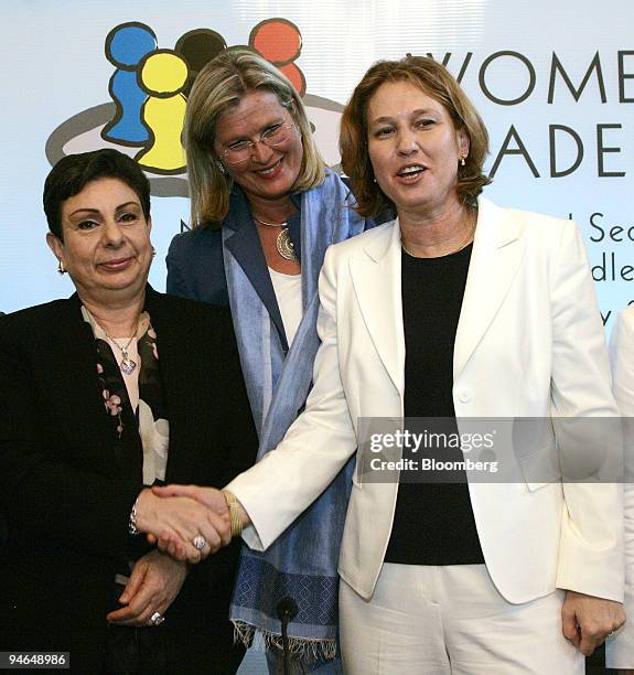 Palestinian Legislative Council member Hanan Ashrawi, left, shakes hands with Israeli Foreign Minister Tzipi Livni as Austrian Foreign Minister...