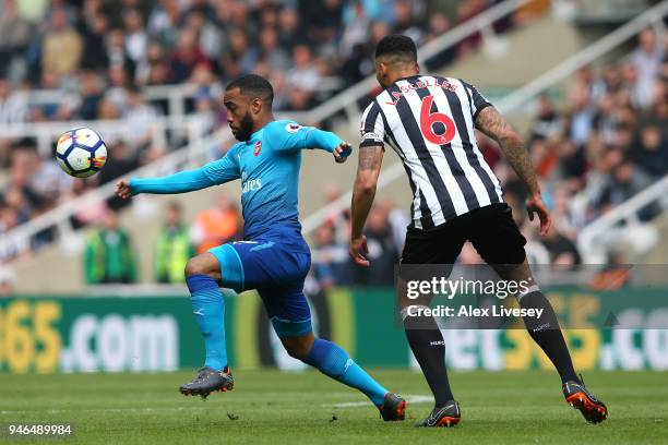 Alexandre Lacazette of Arsenal and Jamaal Lascelles of Newcastle United in action during the Premier League match between Newcastle United and...