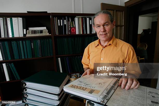 Michael Ragsdale poses with binders of 9/11 related materials in his home in the Maspeth neighborhood of the Queens borough of New York, U.S., on...