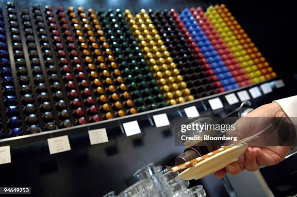 An employee serves Nespresso coffee at a Nestle Nespresso Shop in Bern, Switzerland, Wednesday, Aug. 15, 2007. The world's largest coffee maker is...