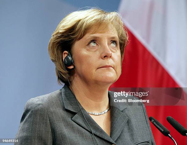 German Chancellor Angela Merkel listens during a press conference during the first summit of the "Weimar Triangle" including representatives from...