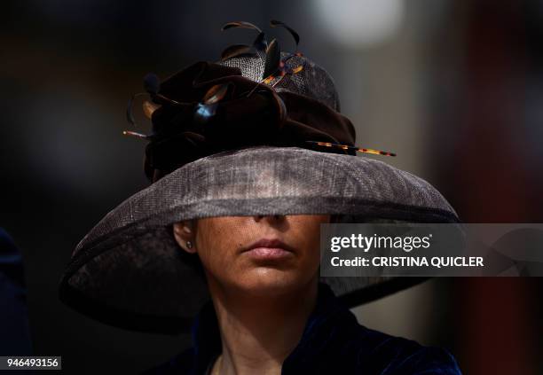 Woman sporting a pamela hat participates in the XXXIII "Enganches" exhibition at the Real Maestranza bullring in Sevilla on April 15, 2018. / AFP...