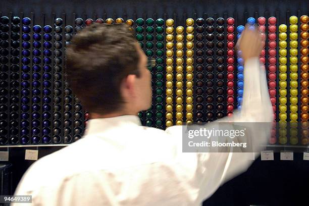 An employee sorts Nespresso coffee capsules at a Nestle Nespresso Shop in Bern, Switzerland, Wednesday, Aug. 15, 2007. The world's largest coffee...