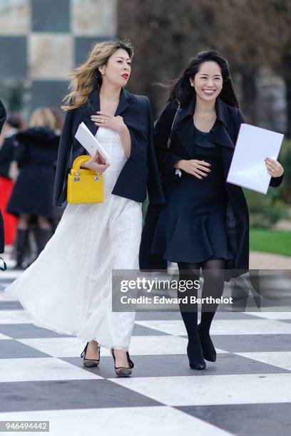 Guest wears a blazer jacket, a yellow lady dior bag, a white dress ; a guest wears a black coat, a black dress, tights, after Dior, during Haute...