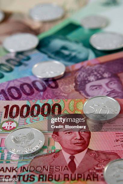 Indonesian rupiah are displayed for a photograph in Jakarta, Indonesia, on Wednesday, Aug. 15, 2007. Record prices for rice, wheat, milk and cooking...