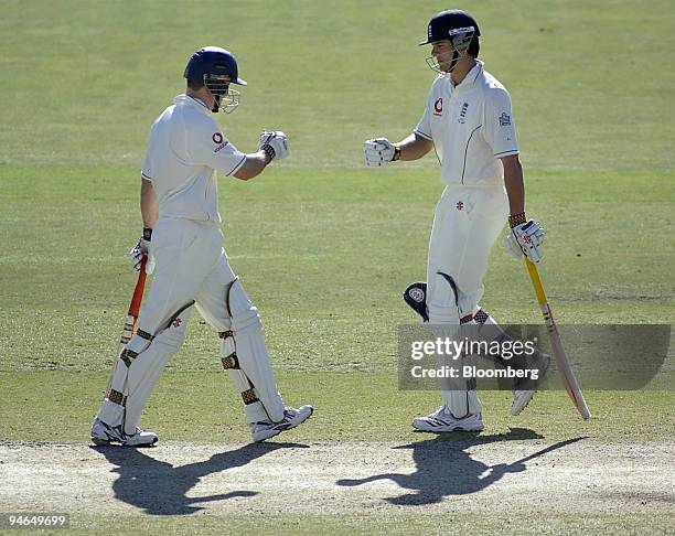 Andrew Strauss, left, and Alastair Cook, both batting for England, meet mid-pitch, on Day 4 of the second Ashes Test match at the Adelaide Oval in...