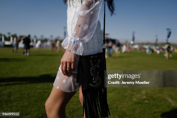Coachella guest wearing a sheer dress and YSL bag during day 1 of the 2018 Coachella Valley Music & Arts Festival Weekend 1 on April 13, 2018 in...