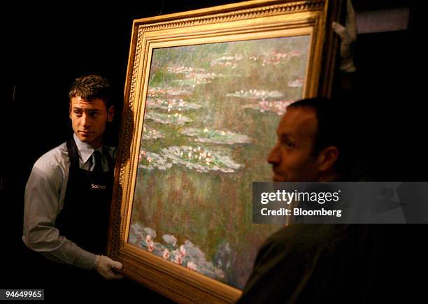 Sotheby's employees hang Claude Monet's 1904 painting entitled ''Nympheas'' at Sotheby's in London, U.K., Tuesday, June 5, 2007. The painting, which...